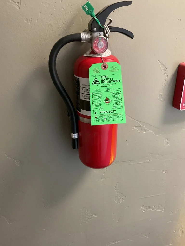 Recharged commercial fire extinguisher mounted on wall in Rio Rancho business